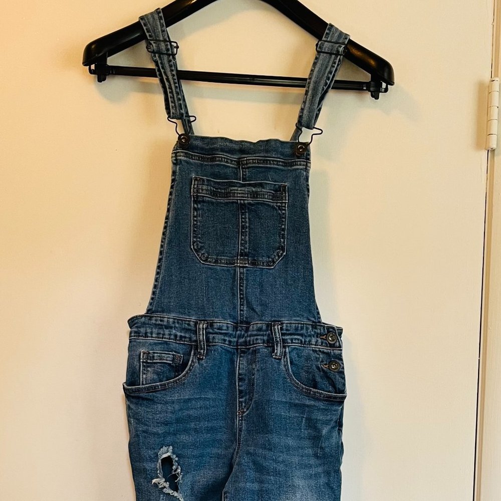 Denim overalls with rips. Perfect condition, barely worn before outgrown.